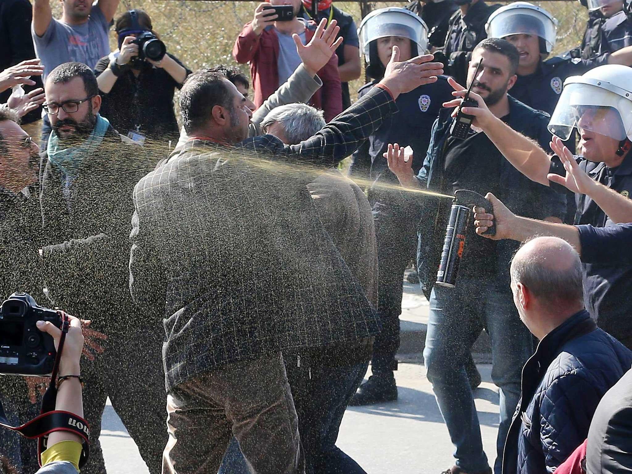 Riot police clash with demonstrators to prevent them from holding a protest to mark the first anniversary of the worst attack in Turkey's modern history