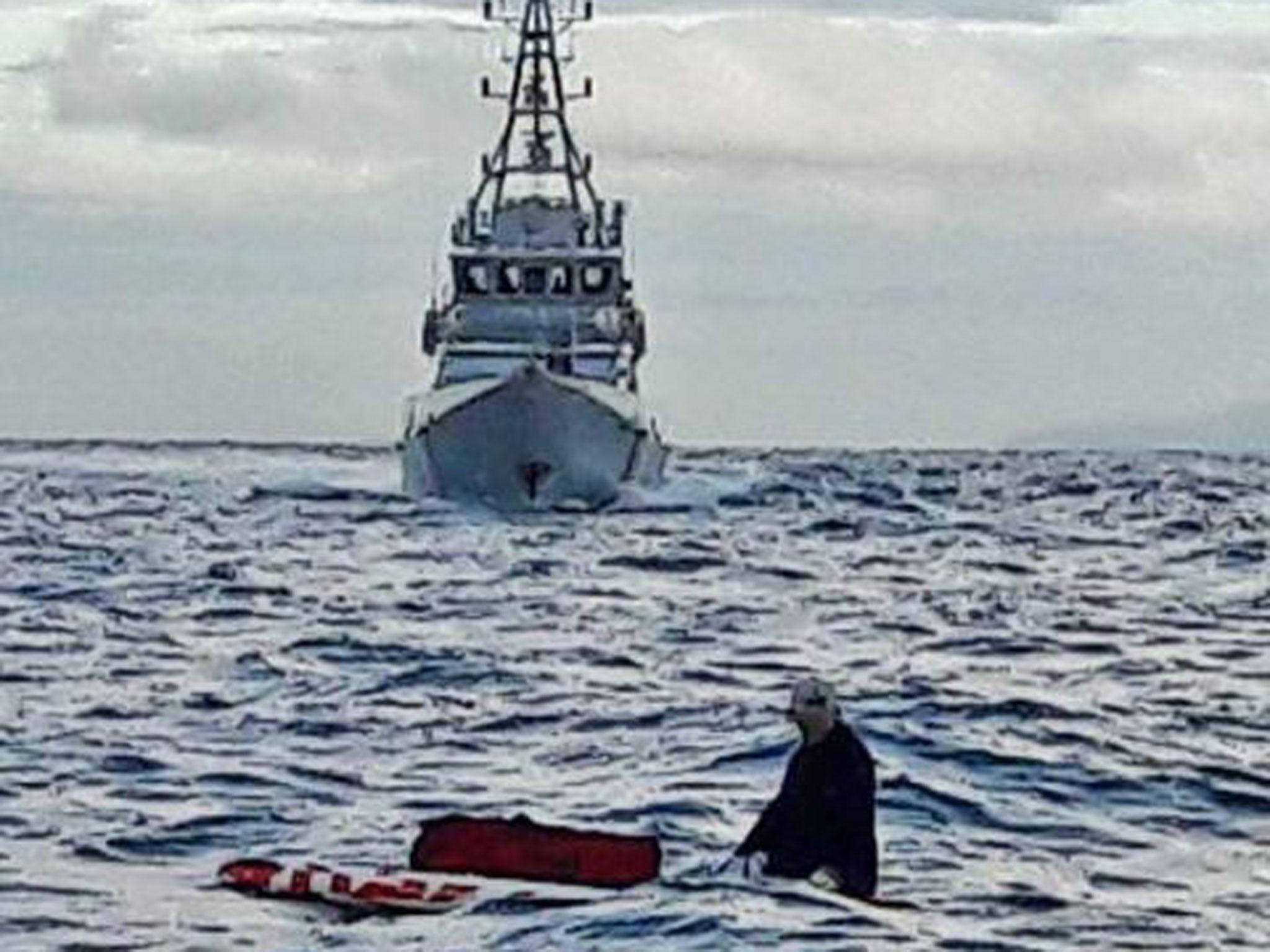 An EU national is picked up seven miles from the UK coastline on a stand-up paddleboard