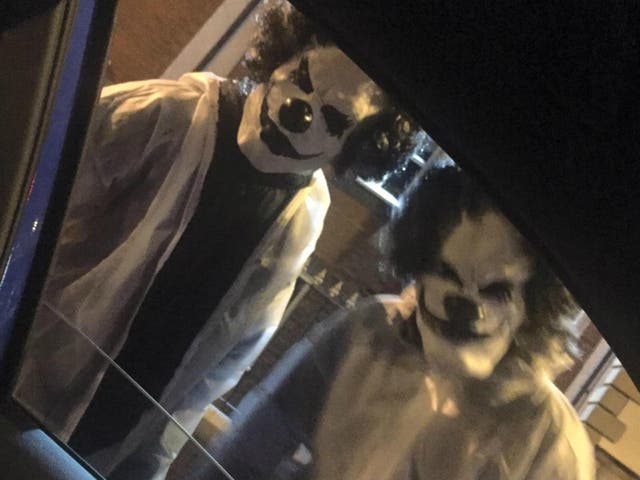 The two clowns allegedly carrying machetes photographed by Kurtis Mulvaney in Manchester
