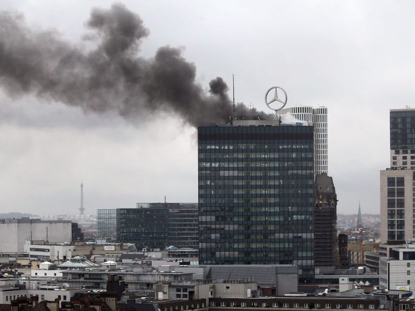 Smoke billows from the roof of the Europa Center in Berlin,Germany