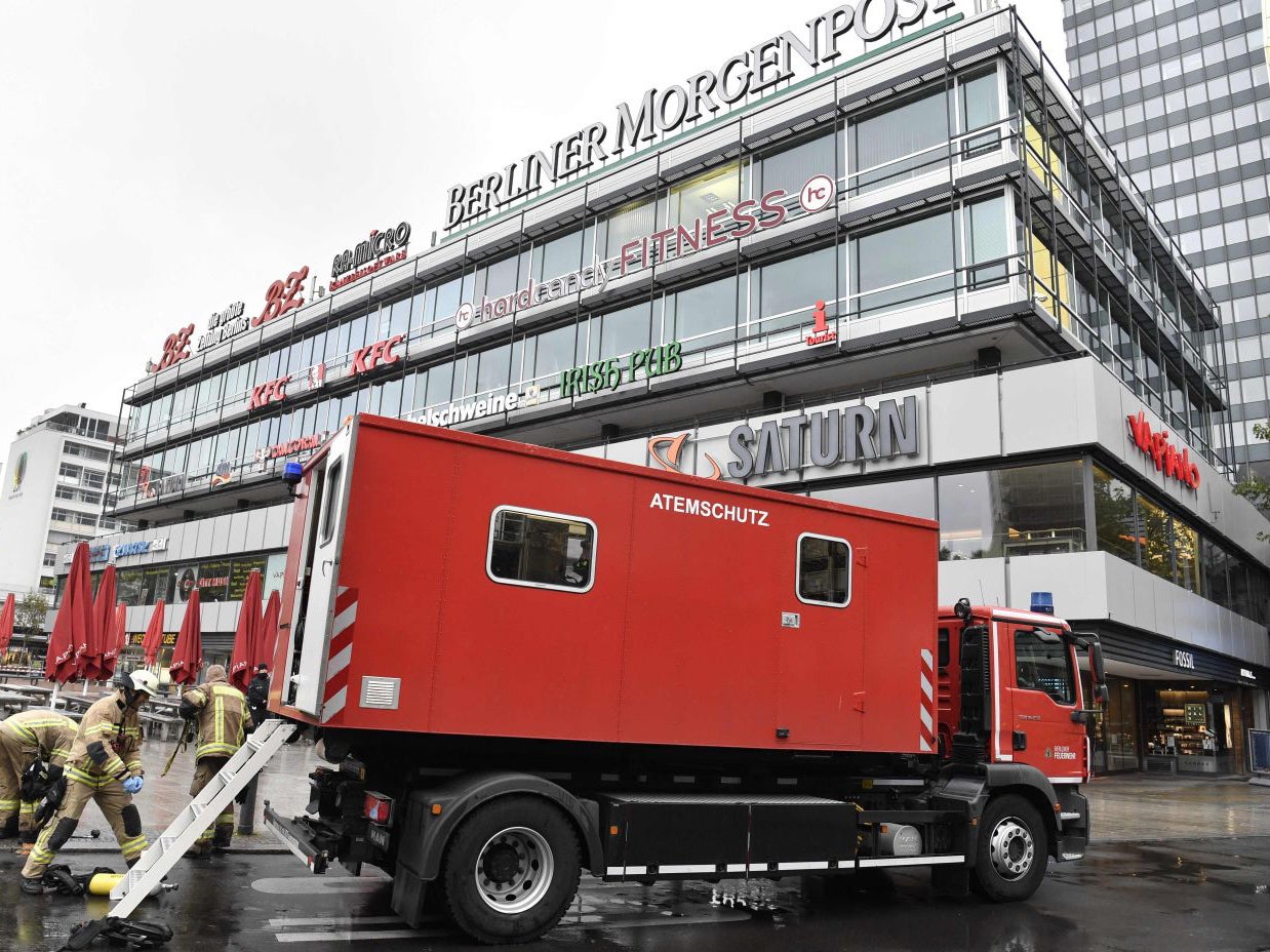 Fire workers work near the Europa-Center in Berlin