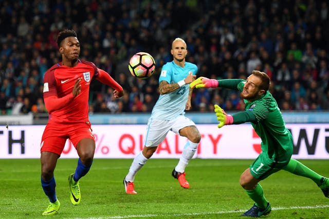 Sturridge battles for the ball with Slovenia's goalkeeper Oblak