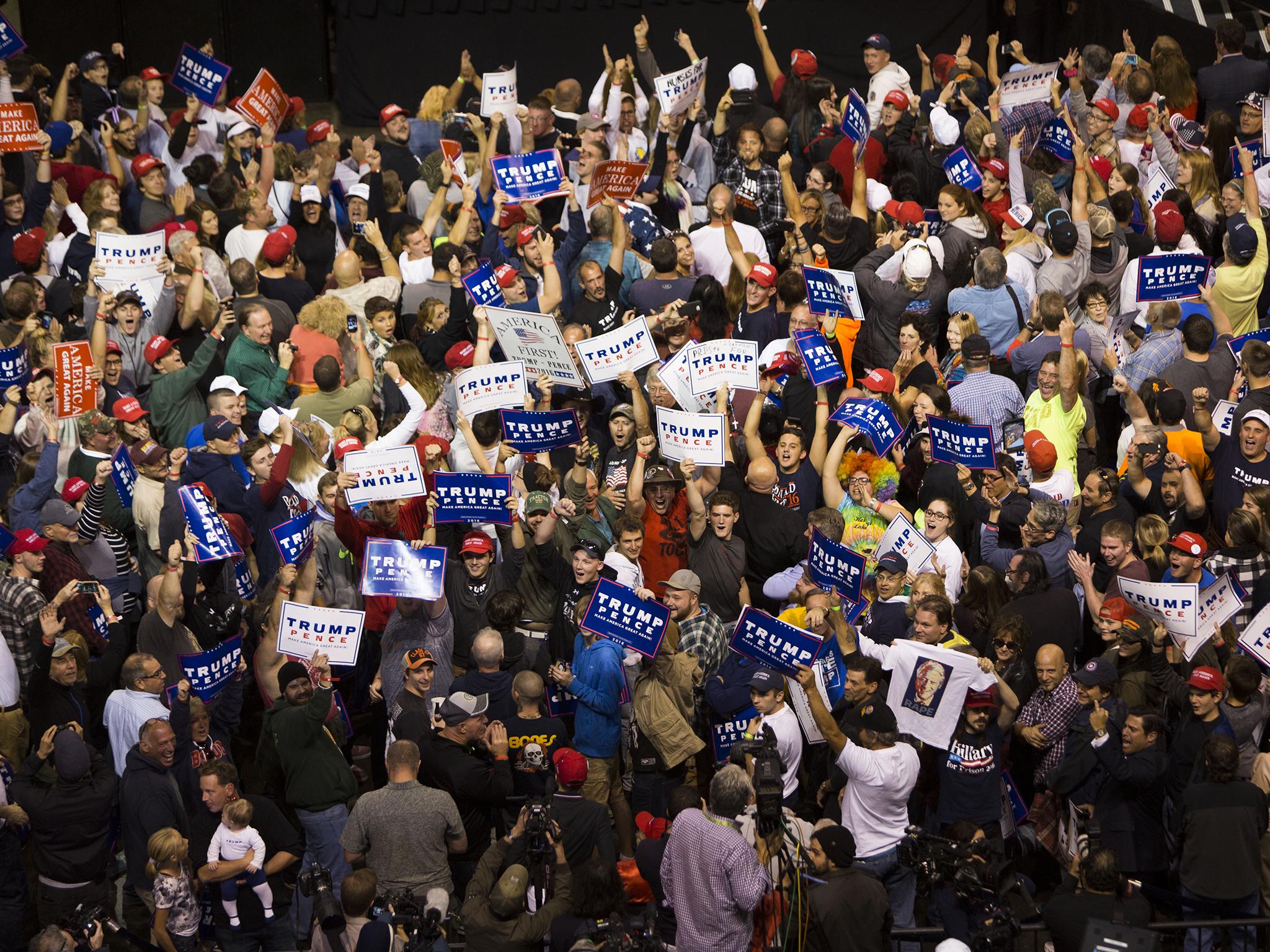 Supporters face the cameras and chant at a campaign rally for Donald Trump in Wilkes-Barre, Pennsylvania
