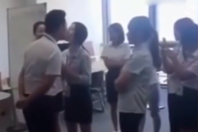 A boss has been caught on camera demanding that his female employees kiss him on the lips