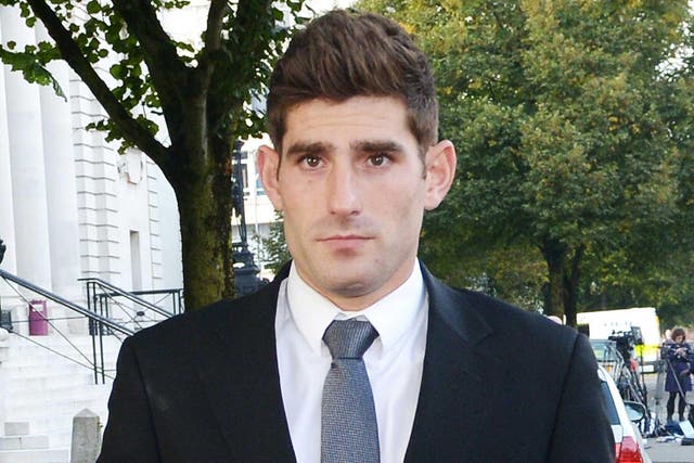 Footballer Ched Evans leaves Cardiff Crown Court, where he has been found not guilty of raping a teenager in a hotel in north Wales 