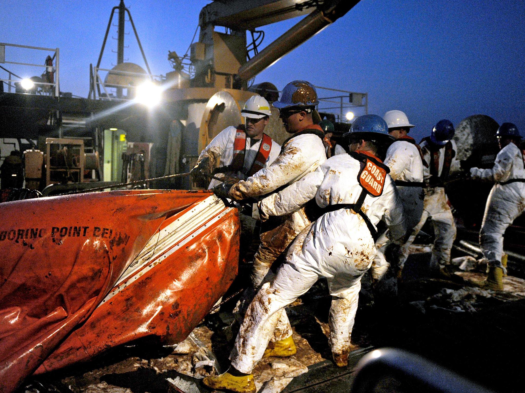 U.S. Department of Defense, crewmembers from USCGC Harry Claiborne (WLM 561) remove an oil covered boom from the ocean May 8, 2010 in the Gulf of Mexico
