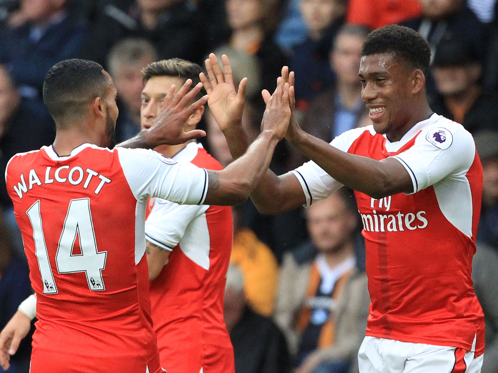 Iwobi celebrates his strike at Hull with Theo Walcott