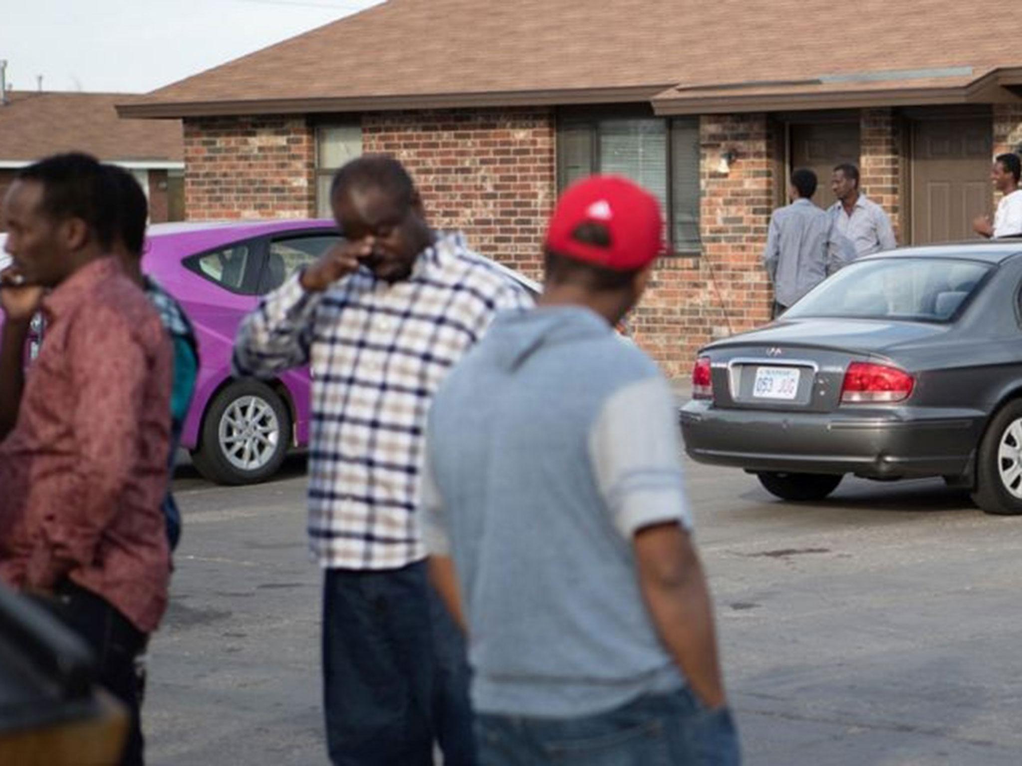People stand outside a mosque located within an apartment complex, which federal authorities allege was to be targeted in a bomb plot by three Kansas men, in Garden City, Kansas, US, 14 October, 2016