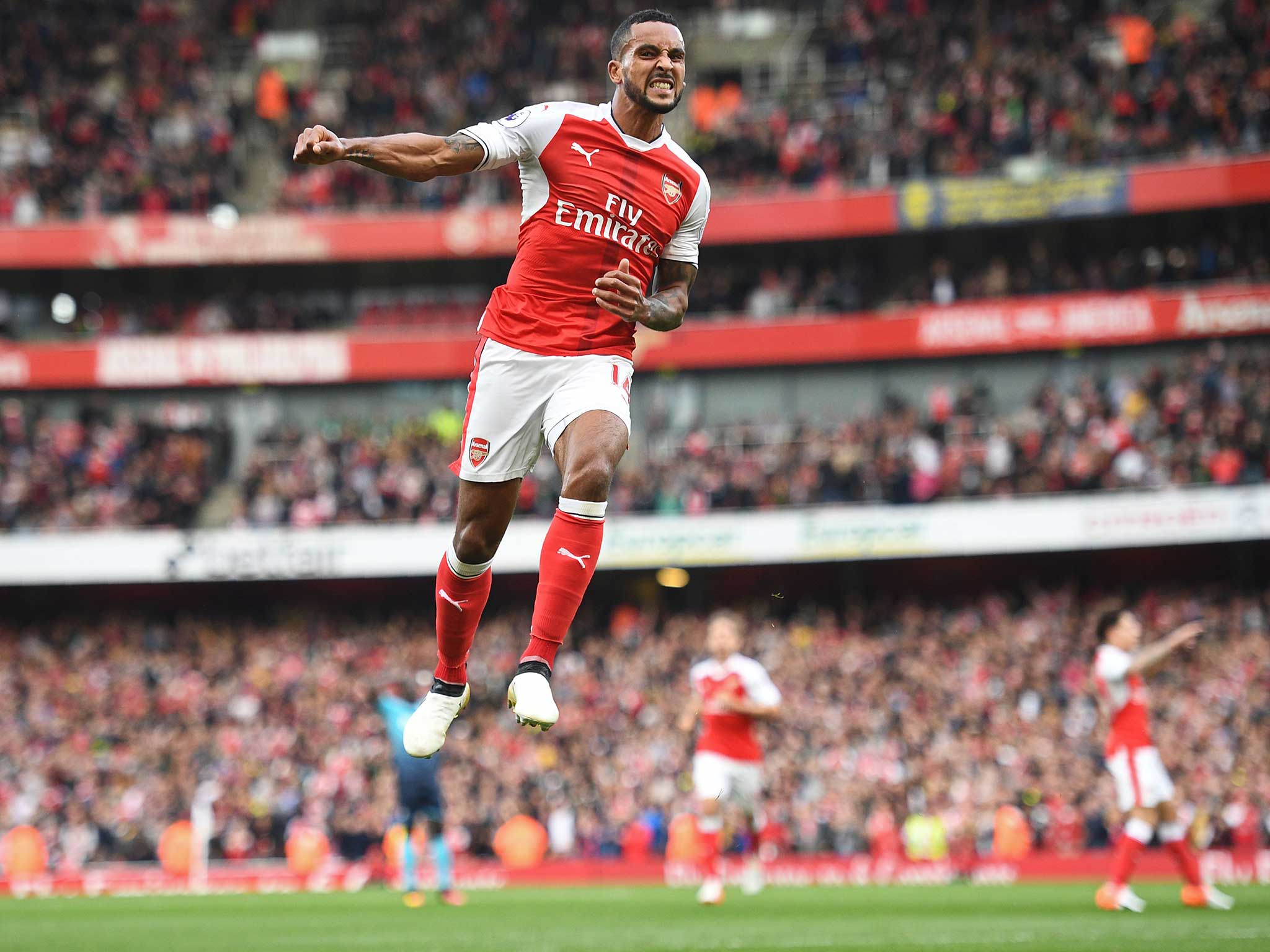 Theo Walcott celebrates his second strike against Swansea