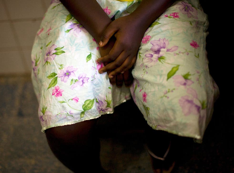 A 15-year-old girl seeking medical treatment waits at an MSF clinic in Monrovia on November 30, 2009 after being raped