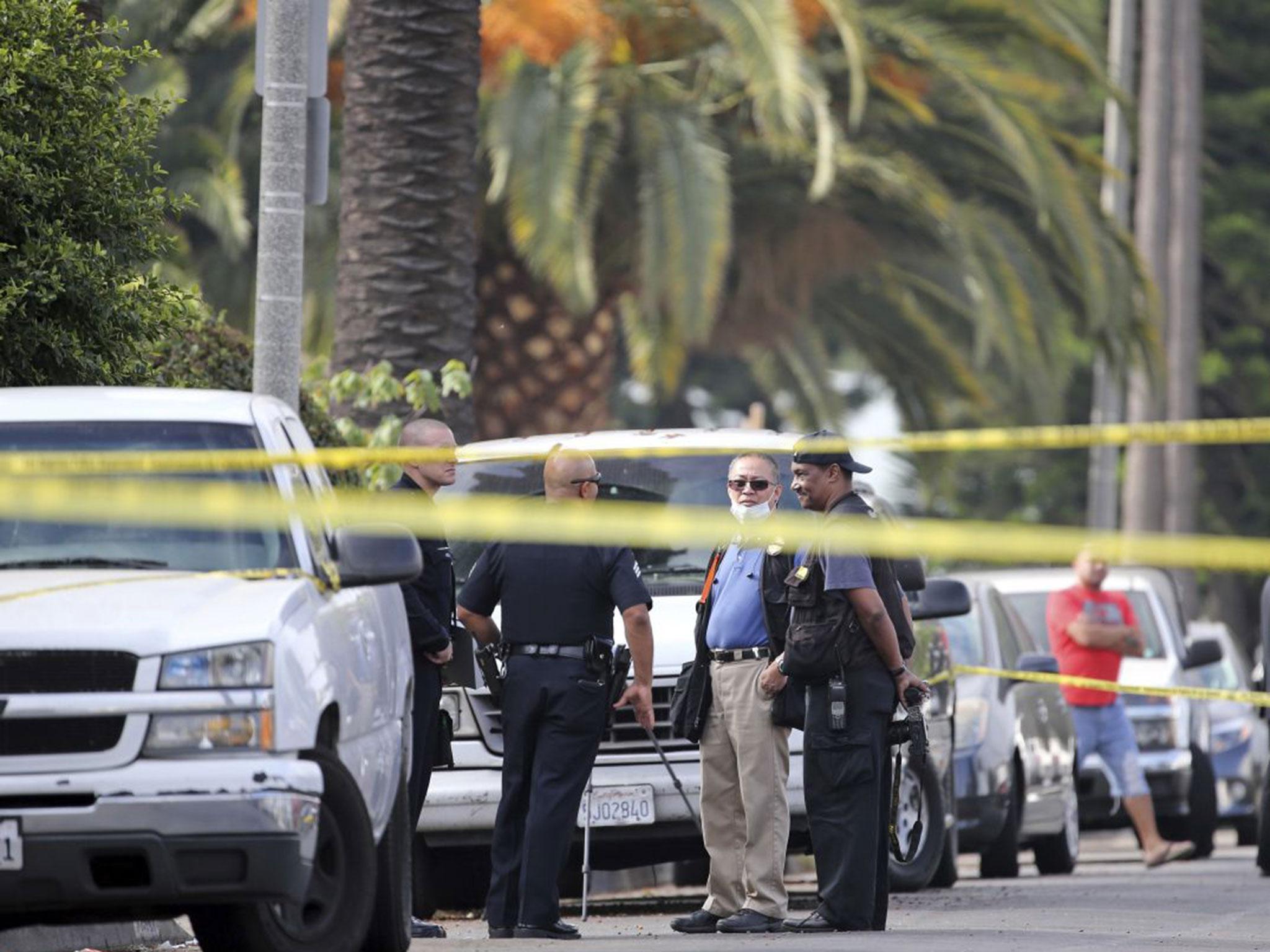 Los Angeles police investigators work the scene of a fatal shooting in the West Adam district