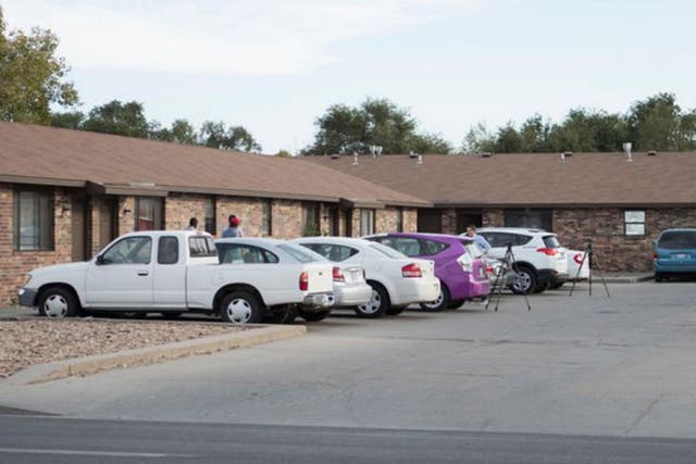 People stand outside the mosque located within the apartment complex, allegedly targeted by three Kansas militiamen