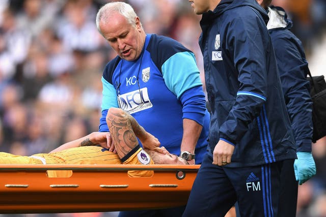 Toby Alderweireld is carried off the field on a stretcher after suffering leg and knee injuries