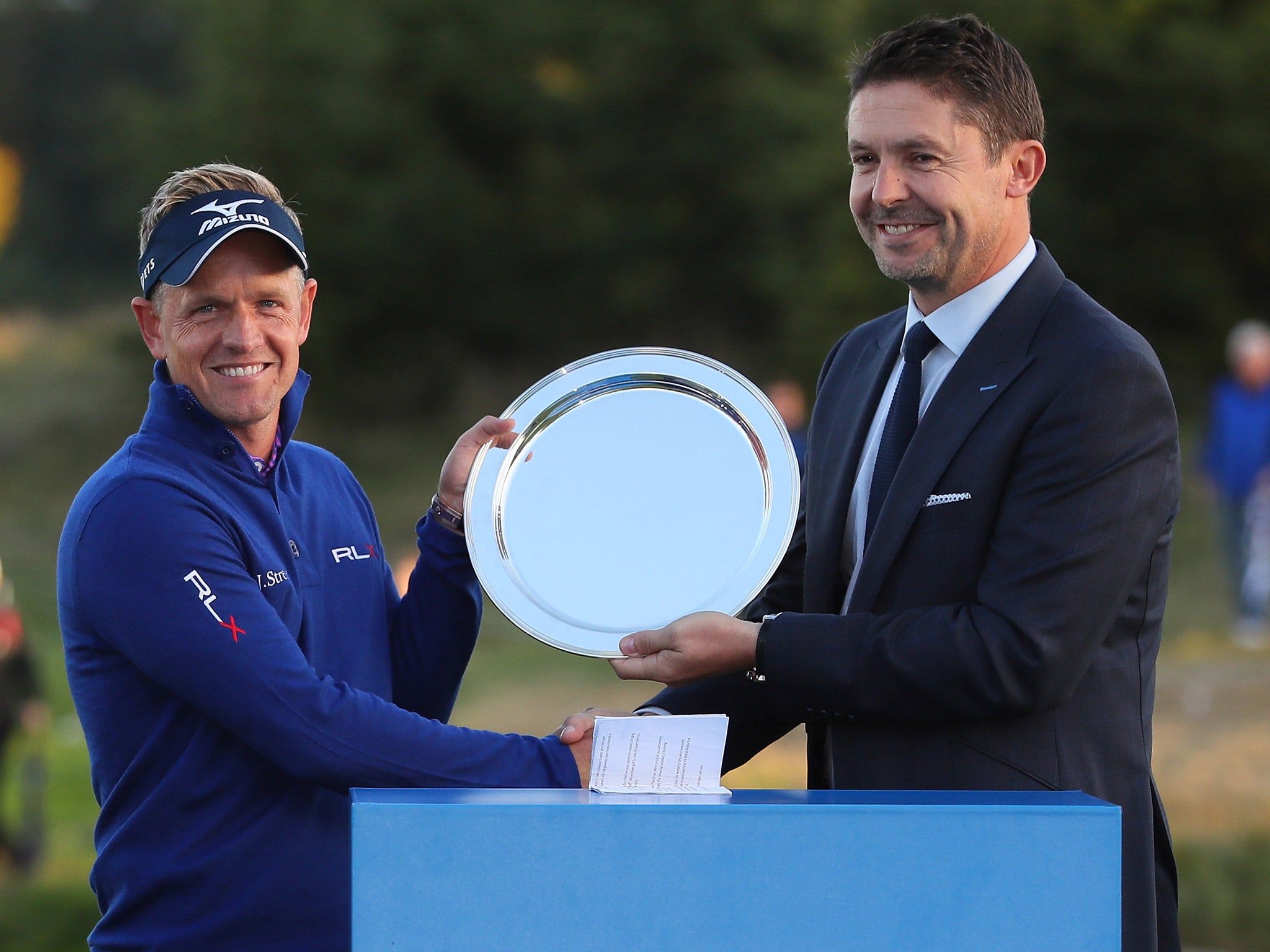 Luke Donald is presented with a trophy after hosting the British Masters at The Grove