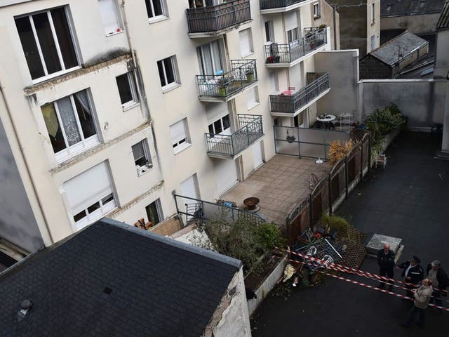 Police inspecting the damage at the site where the remains of the balcony can be seen on the ground