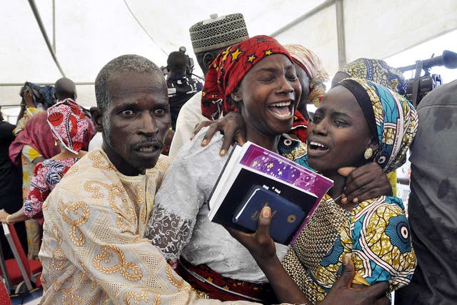 One of the kidnapped girls celebrates with family members during an church survives held in Abuja, Nigeria,
