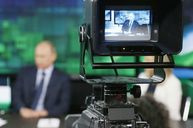 Russian President Vladimir Putin is seen on the screen of a television camera during his visit to the new studio complex of television channel 'Russia Today' in Moscow