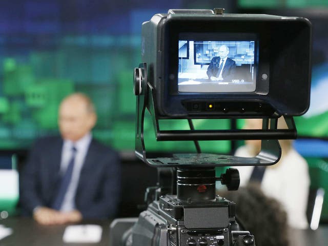 Russian President Vladimir Putin is seen on the screen of a television camera during his visit to the new studio complex of television channel 'Russia Today' in Moscow