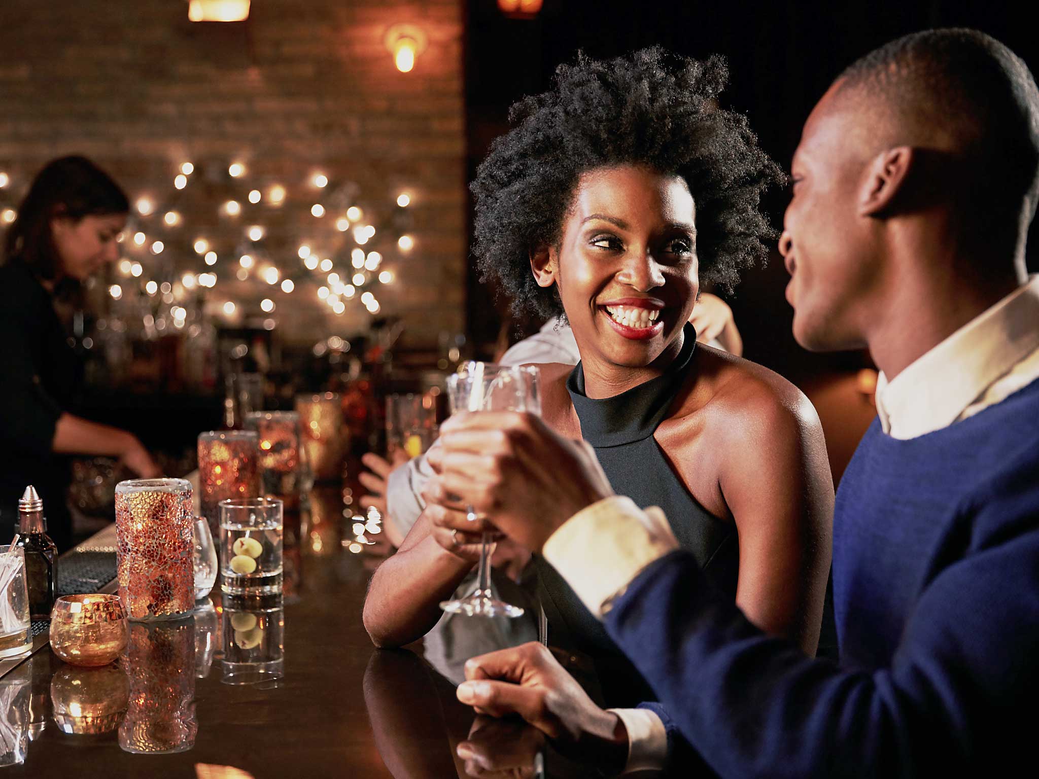 Couple Enjoying Night Out At Cocktail Bar