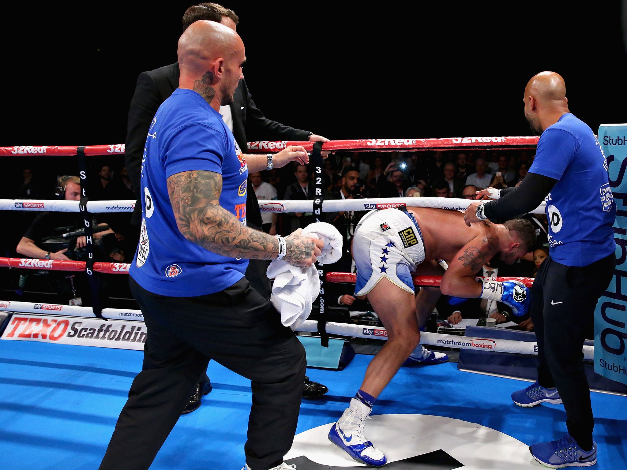 Tony Bellew 'attempts' to leave the ring to confront David Haye in Liverpool on Saturday. He had to be 'held back'