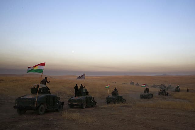 A Kurdish Peshmerga convoy drives towards the front line in Khazer, about 20 miles east of Mosul