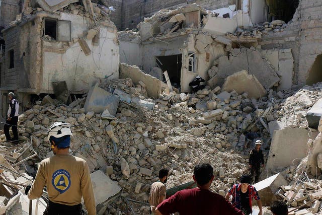 Syrian Civil Defence workers search through the rubble in rebel-held eastern Aleppo, Syria