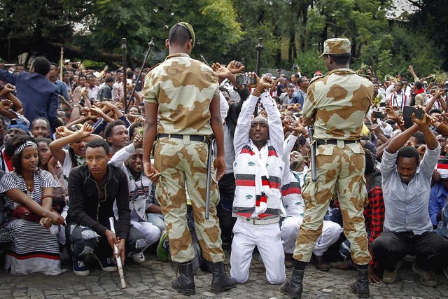 Ethiopian soldiers try to stop protesters in Bishoftu, in the Oromia region of Ethiopia