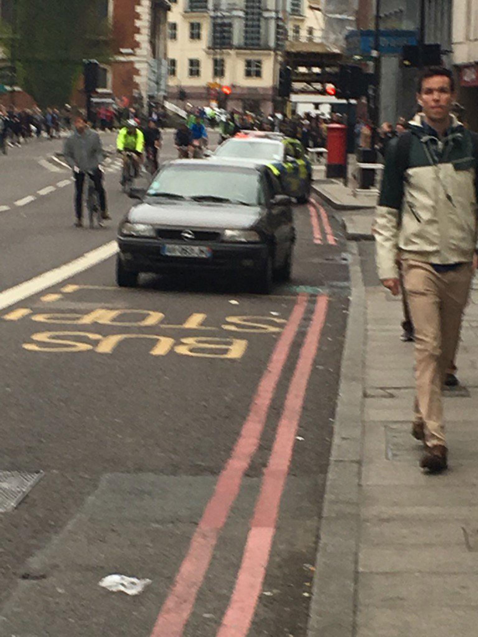 Officers are investigating a black car parked in a bus lane on Borough High Street outside Sainsbury's