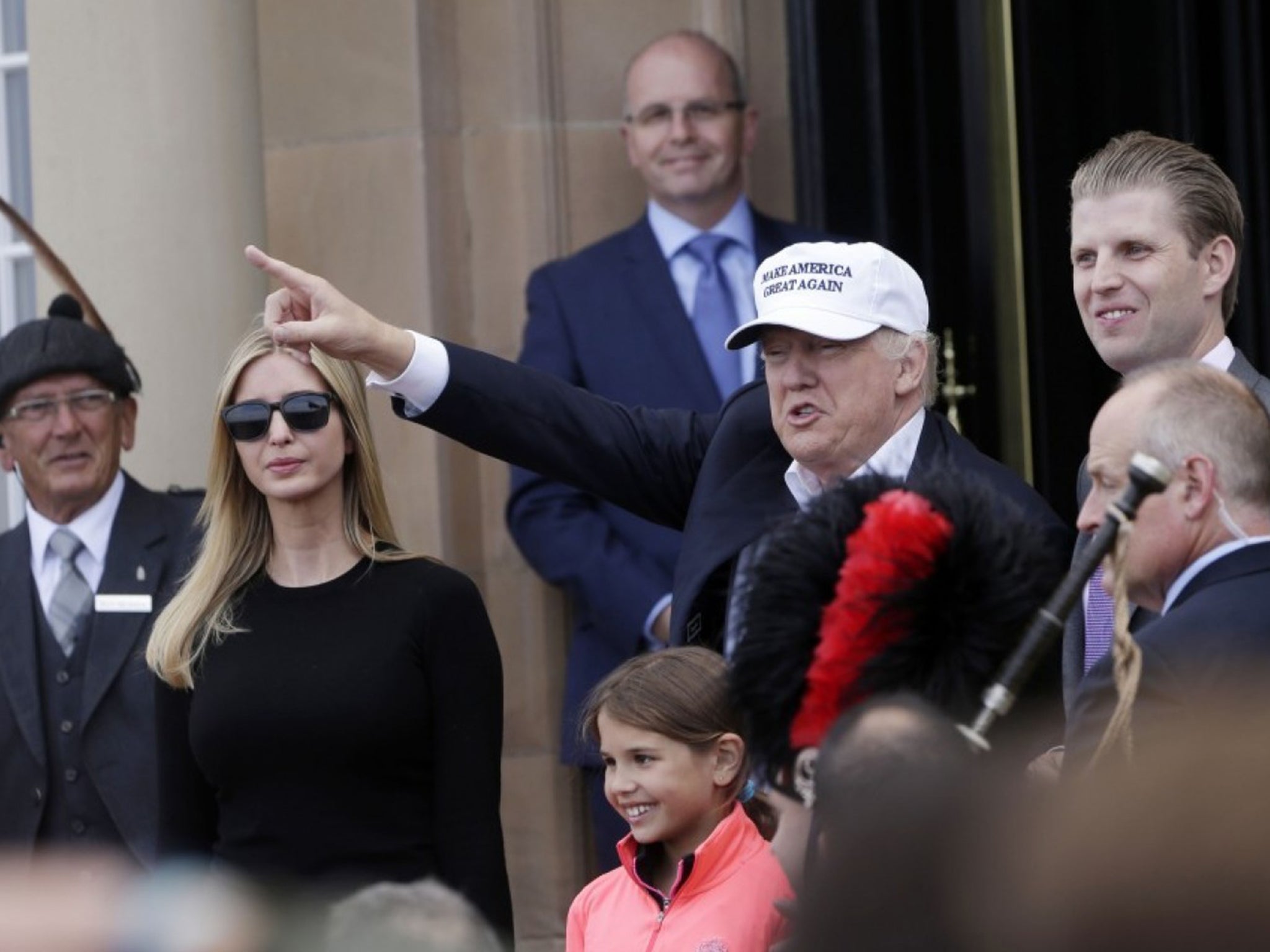 Donald Trump, presumptive Republican presidential nominee, gestures as he arrives with his daughter, Ivanka Trump, left, granddaughter, Kai Trump, bottom, and son, Eric Trump, right, at Trump Turnberry Resort in Turnberry on Friday, June 24, 2016
