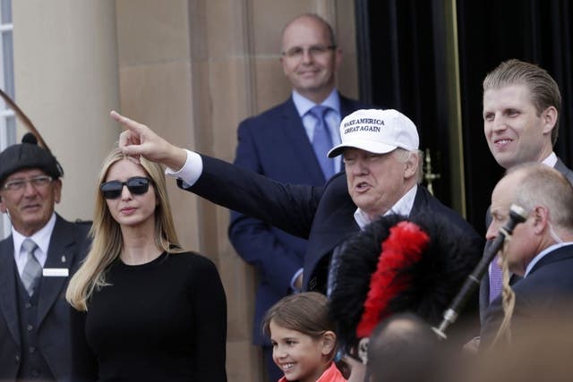 Donald Trump, presumptive Republican presidential nominee, gestures as he arrives with his daughter, Ivanka Trump, left, granddaughter, Kai Trump, bottom, and son, Eric Trump, right, at Trump Turnberry Resort in Turnberry on Friday, June 24, 2016