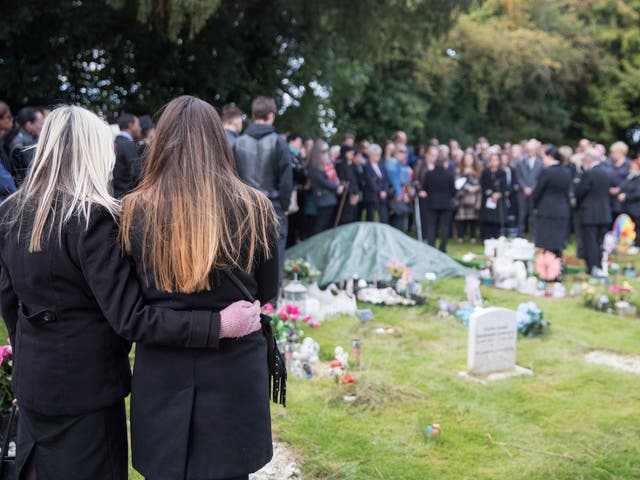 Mourners walk through the cemetery for the funeral of a baby girl who was found dead on a footpath earlier this year at Wolvercote Cemetery