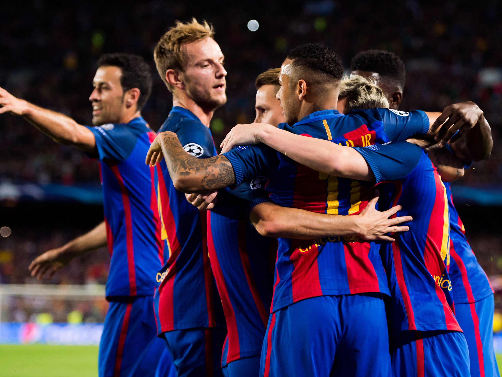 Barcelona players celebrate Messi's first goal