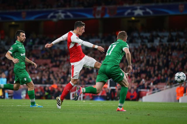Mesut Ozil volleys home his third goal at The Emirates
