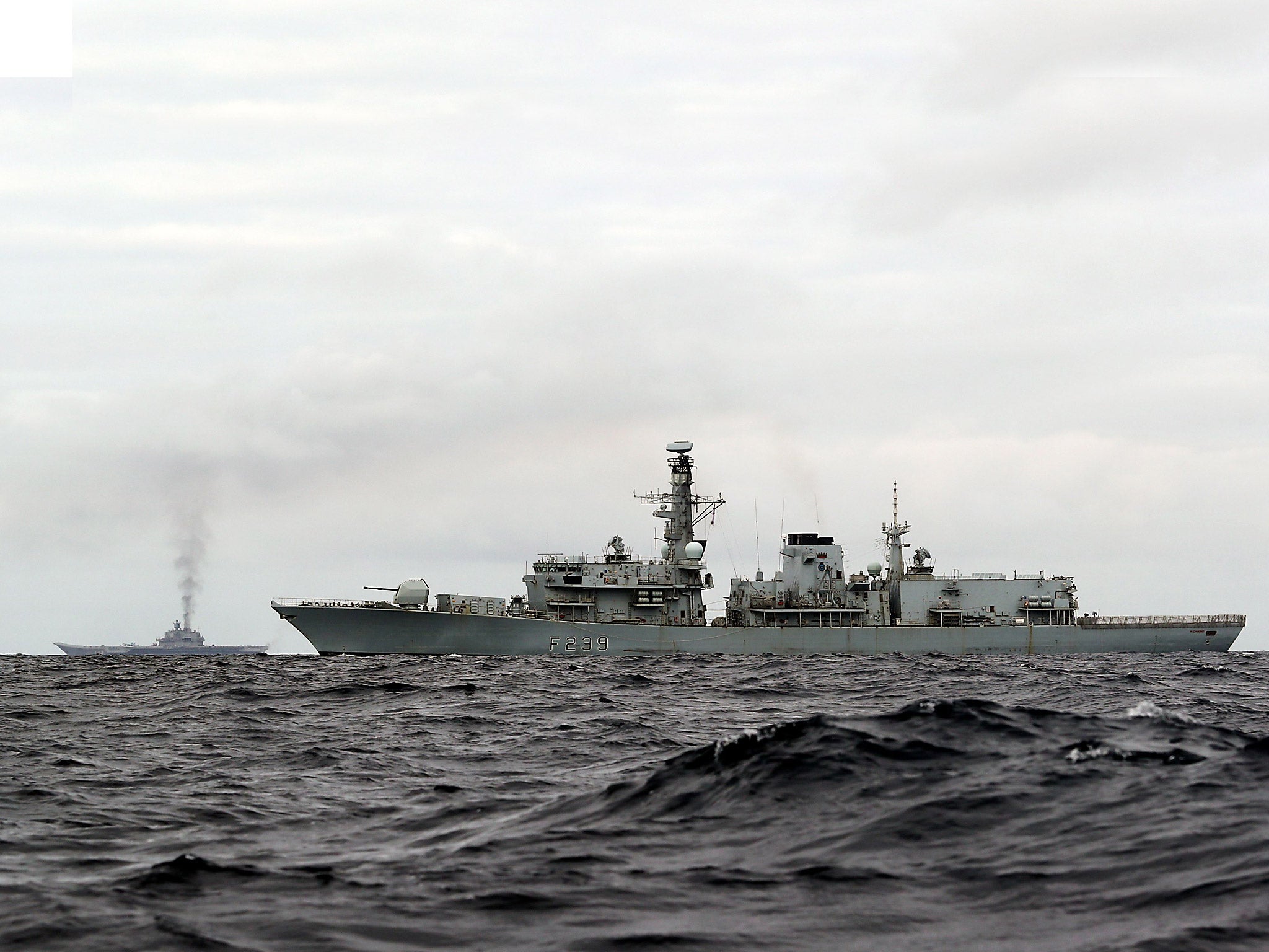 HMS Richmond (front), a Type 23 Duke Class frigate, observing aircraft carrier, which is part of a Russian task group, during transit through the North Sea
