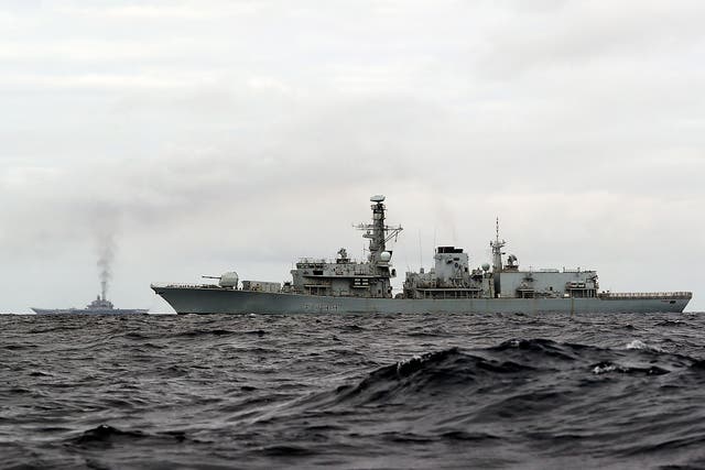 HMS Richmond (front), a Type 23 Duke Class frigate, observing aircraft carrier, which is part of a Russian task group, during transit through the North Sea
