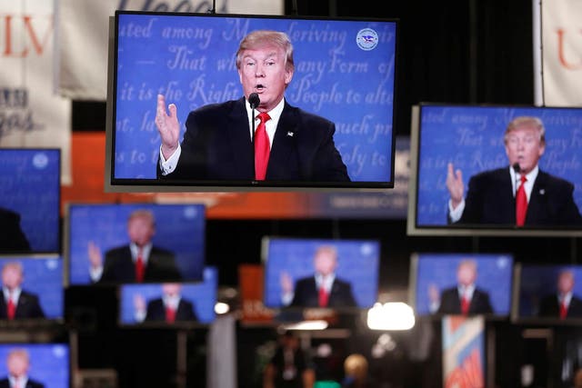 Republican U.S presidential nominee Donald Trump is shown on TV monitors in the media filing room on the campus of University of Nevada