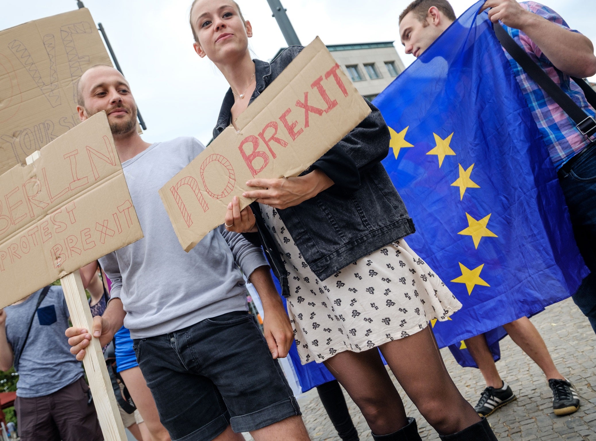 British expats hold up signs to protest for the United Kingdom to remain in the European Union on 2 July 2016 in Berlin, Germany