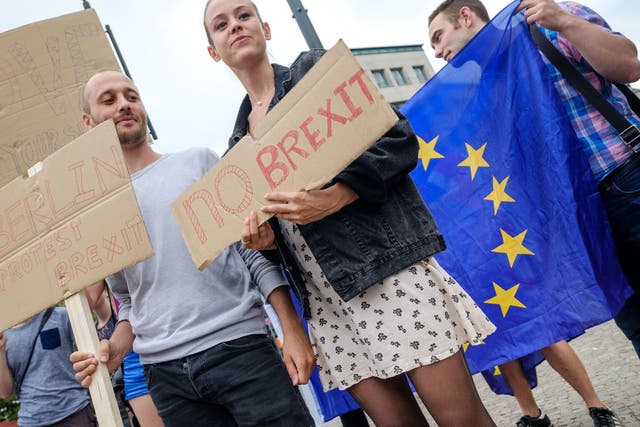 British expats hold up signs to protest for the United Kingdom to remain in the European Union on July 2, 2016 in Berlin, Germany