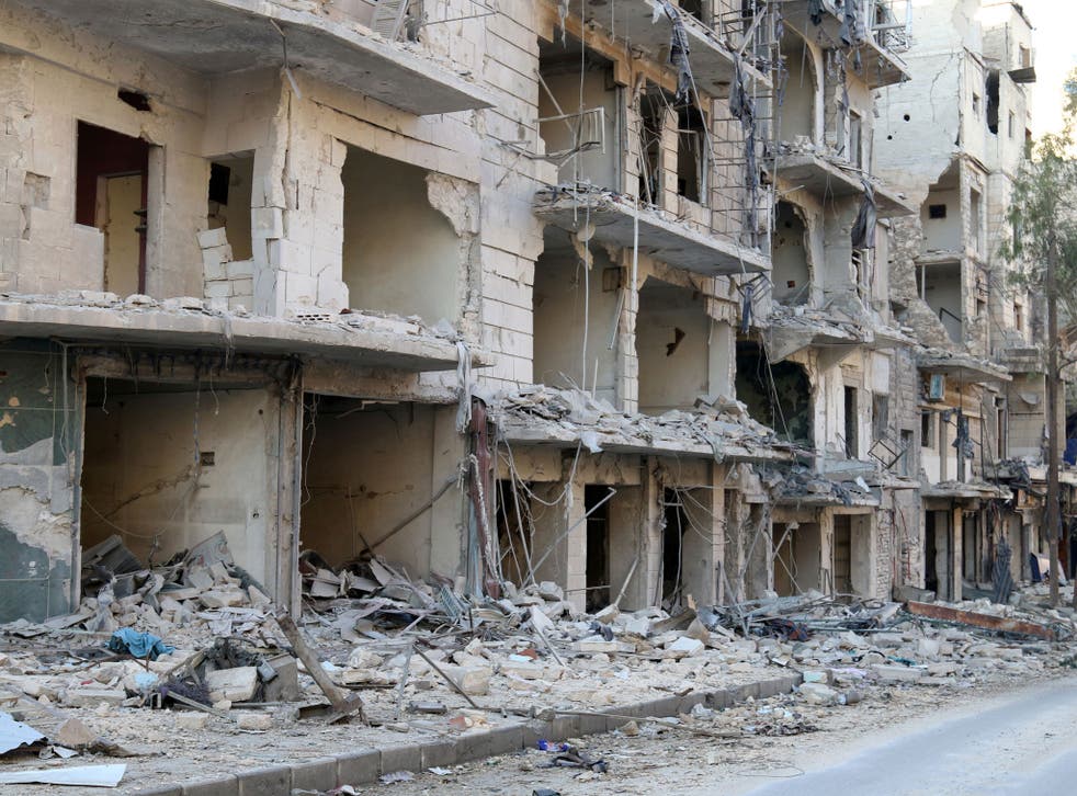 A man walks past damaged buildings in the rebel held besieged al-Sukkari neighbourhood of Aleppo