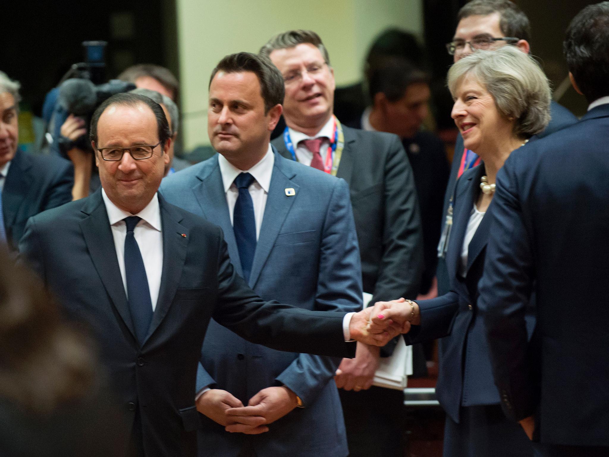Theresa May mingles with other EU leaders at the summit in Brussels