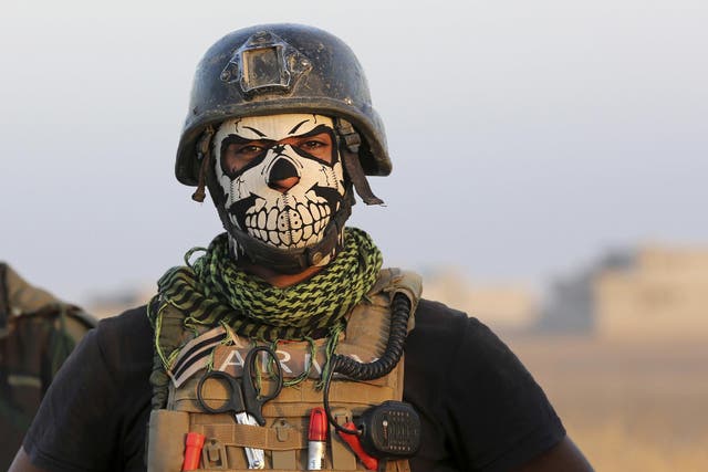 A member of Iraq's elite Special Forces pauses as they advance toward Mosul on Thursday