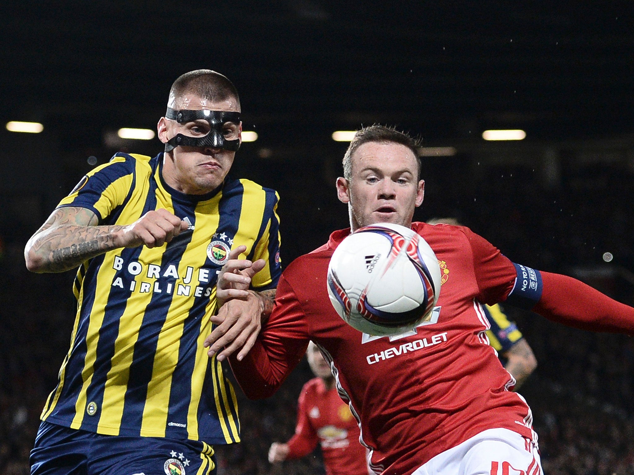 Skrtel and Rooney battle for the ball at Old Trafford