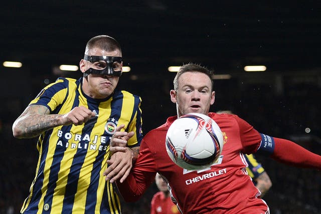 Skrtel and Rooney battle for the ball at Old Trafford