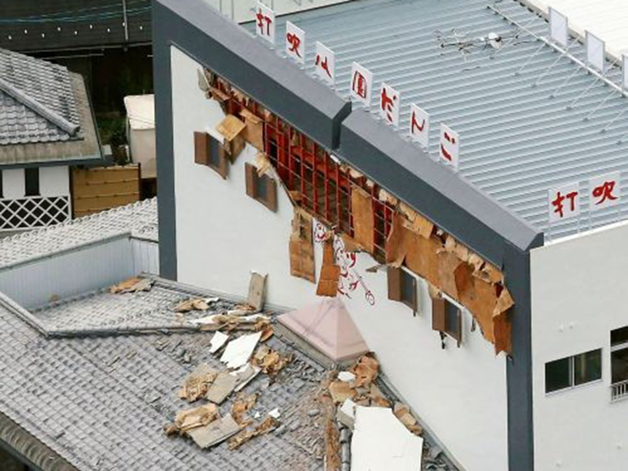 Debris fallen from the damaged wall of a building scattered on a rooftop in Kurayoshi, Tottori prefecture