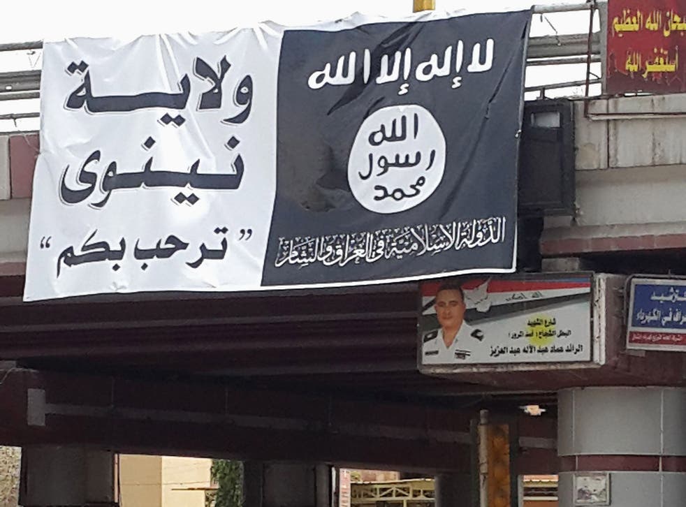 A flag belonging to the Islamic State in Iraq and the Levant (ISIL) along a street in the city of Mosul