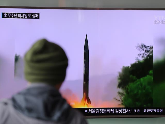 A man watches a TV news program showing a file image of missile launch conducted by North Korea, at the Seoul Railway Station in Seoul, South Korea