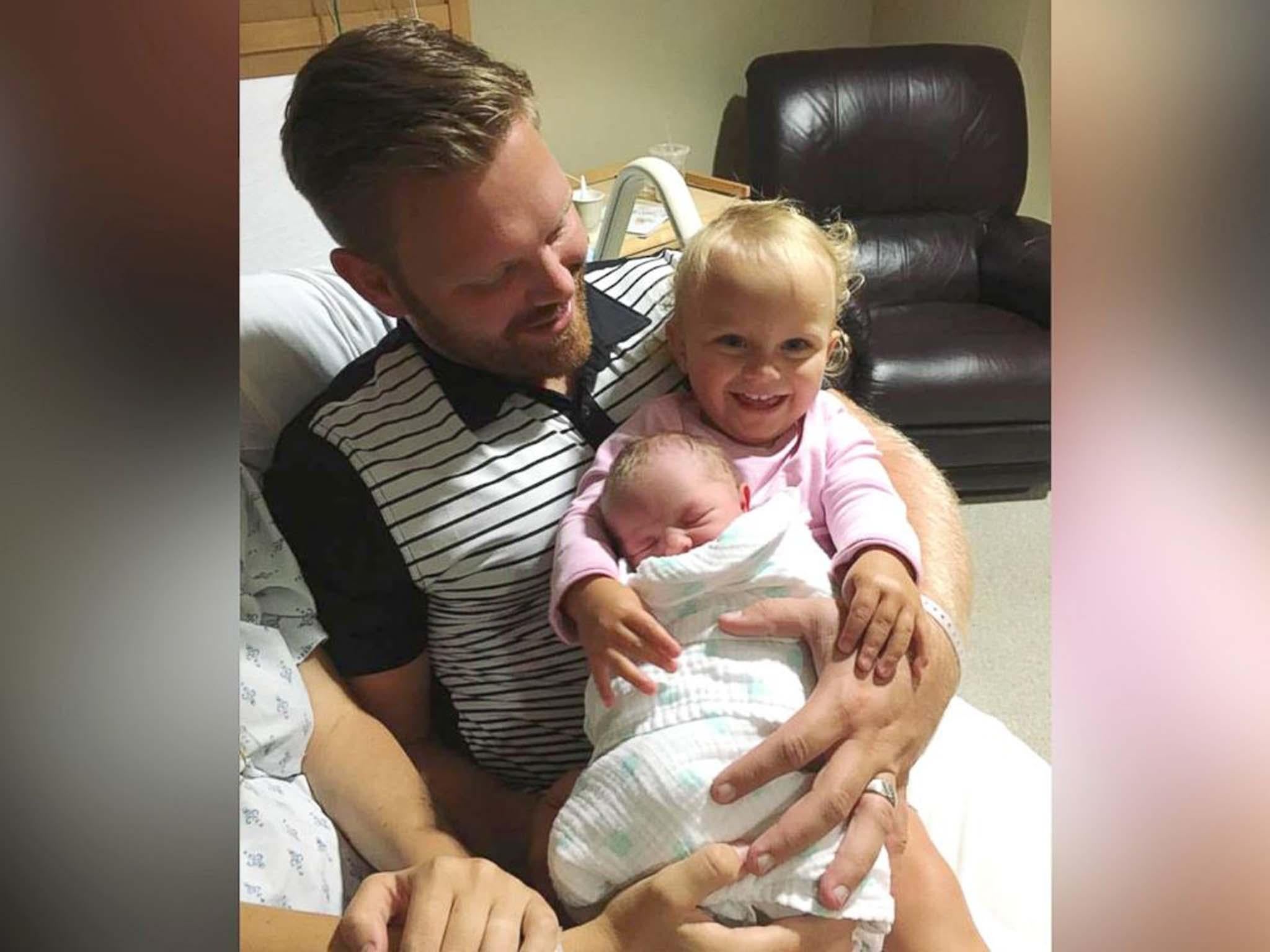 Father, David Vinje photographed with his daughters, Freya, 1 and Elowen, 2 months