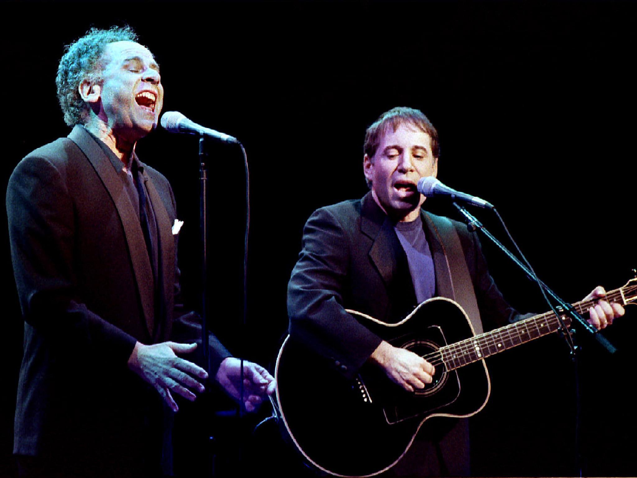 The duo perform ‘The Boxer’ during a benefit concert in Los Angeles, 1993
