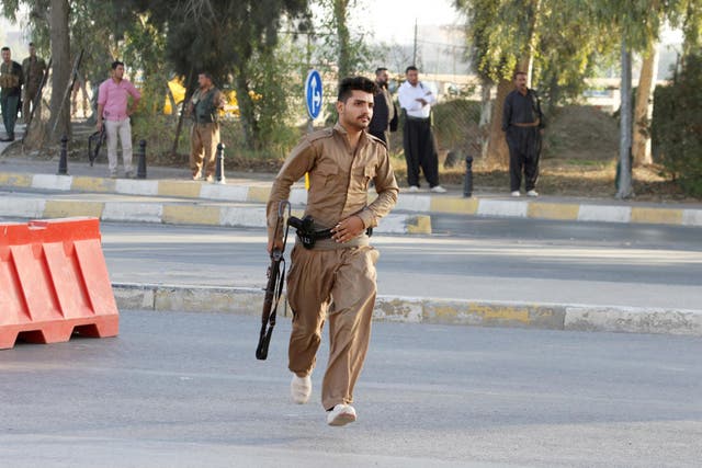 A member of the Kurdish peshmerga force force runs during the Isis attack on Kirkuk