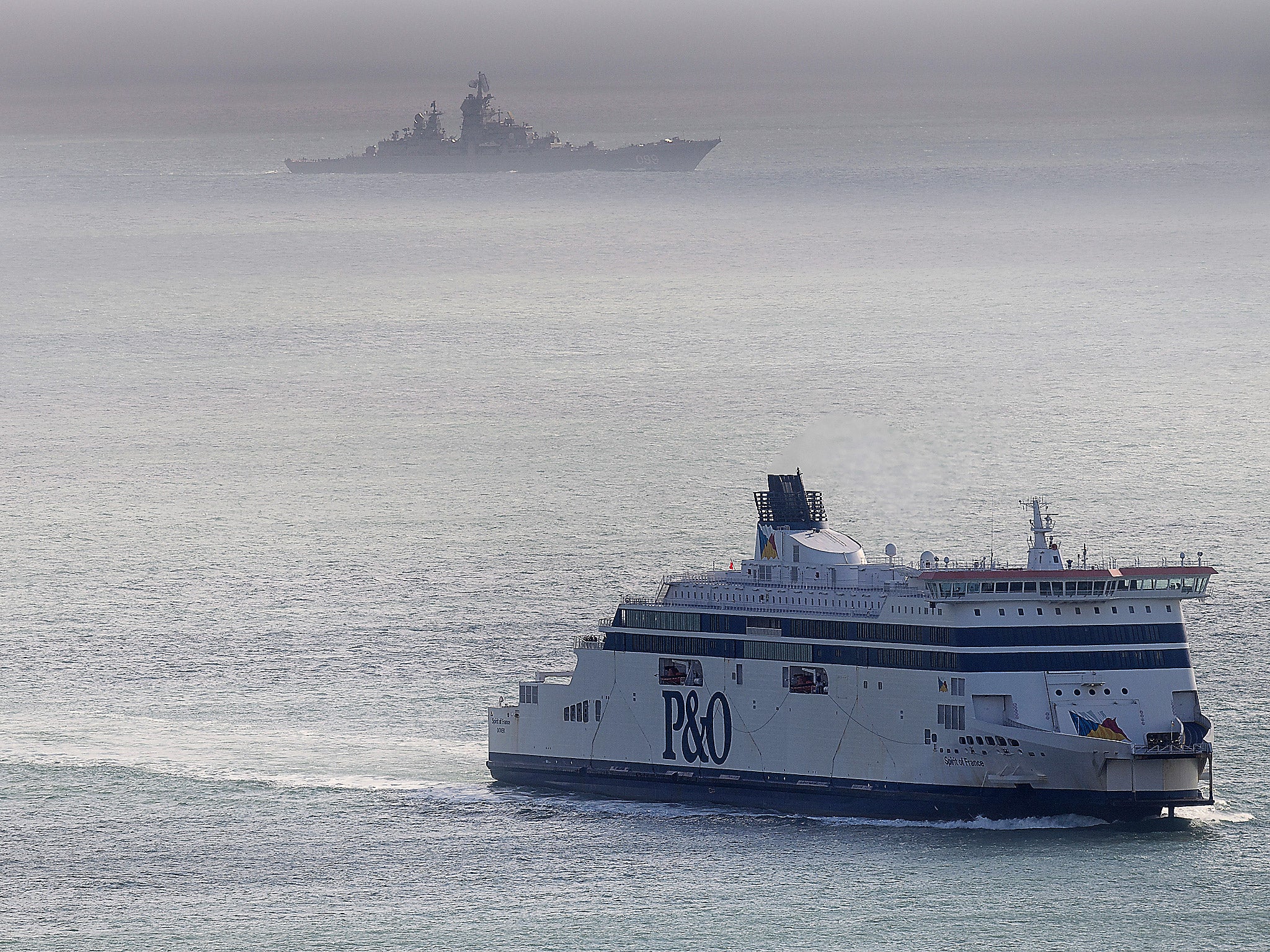 A Russian Naval vessel passes a ferry in the English Channel